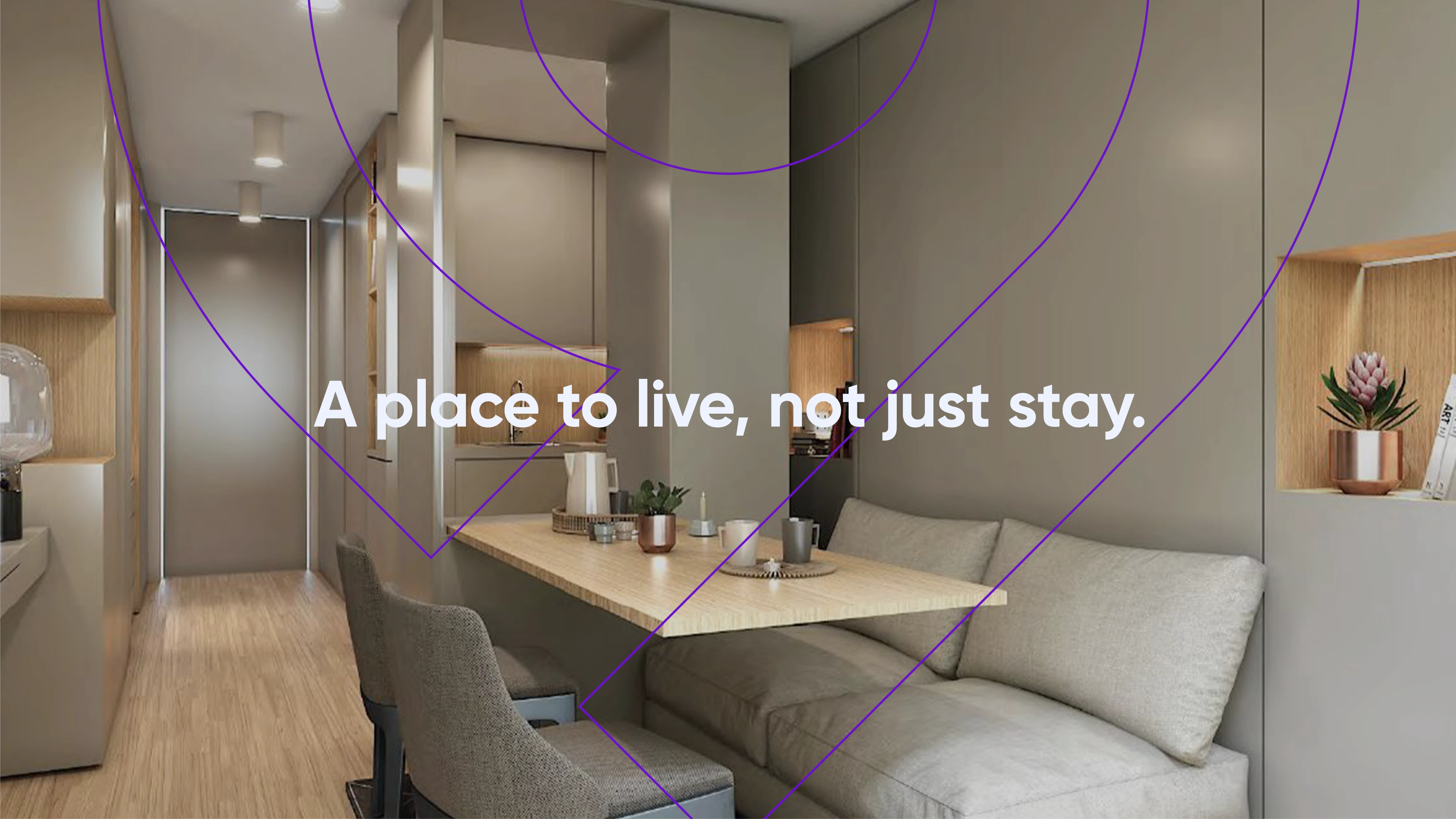 Interior of a modern, minimalist apartment with a compact kitchen, wooden dining table, and cozy sofa. The text "A place to live, not just stay" emphasizes a comfortable and elegant urban life.